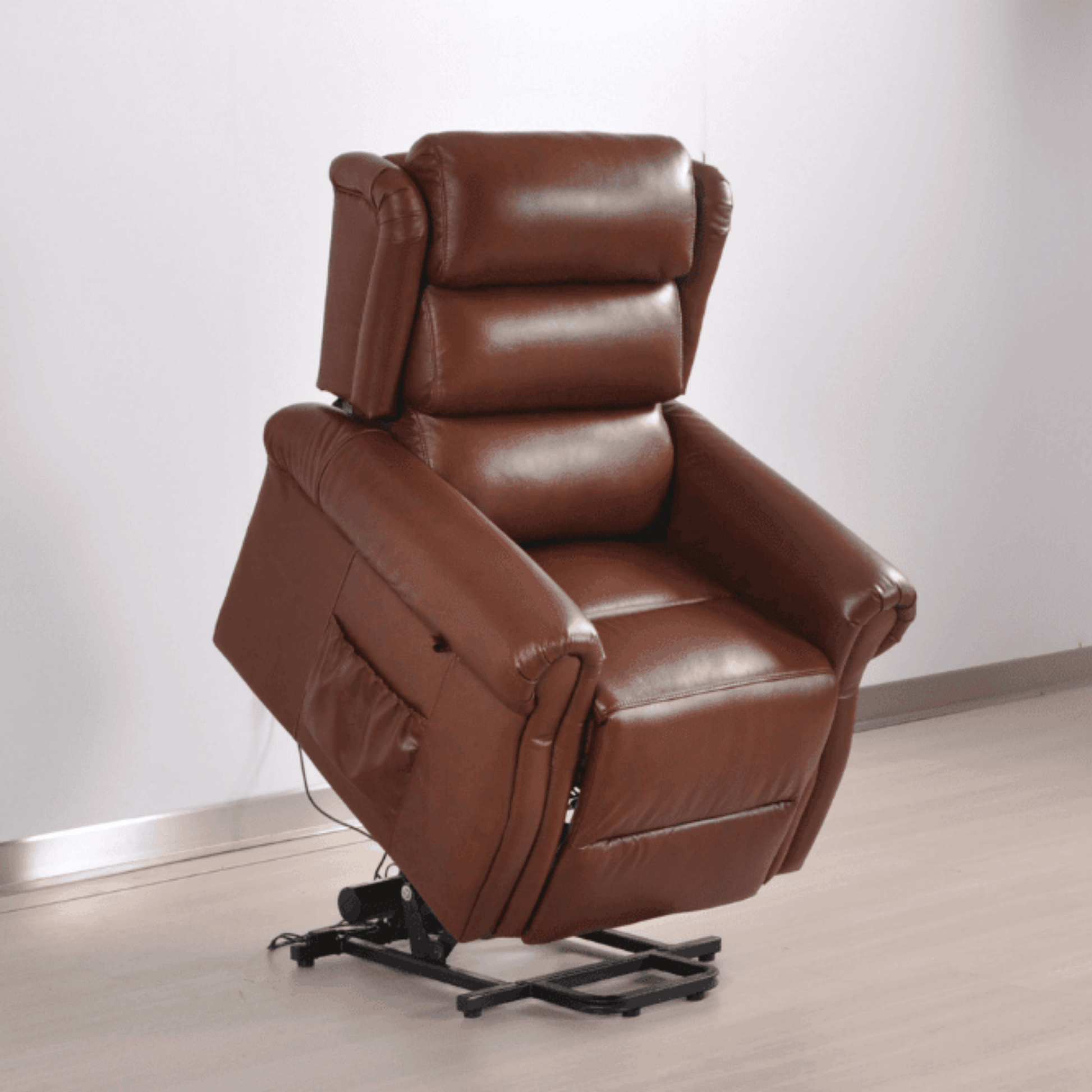Brown leather recliner chair on a light wooden floor with a white wall background