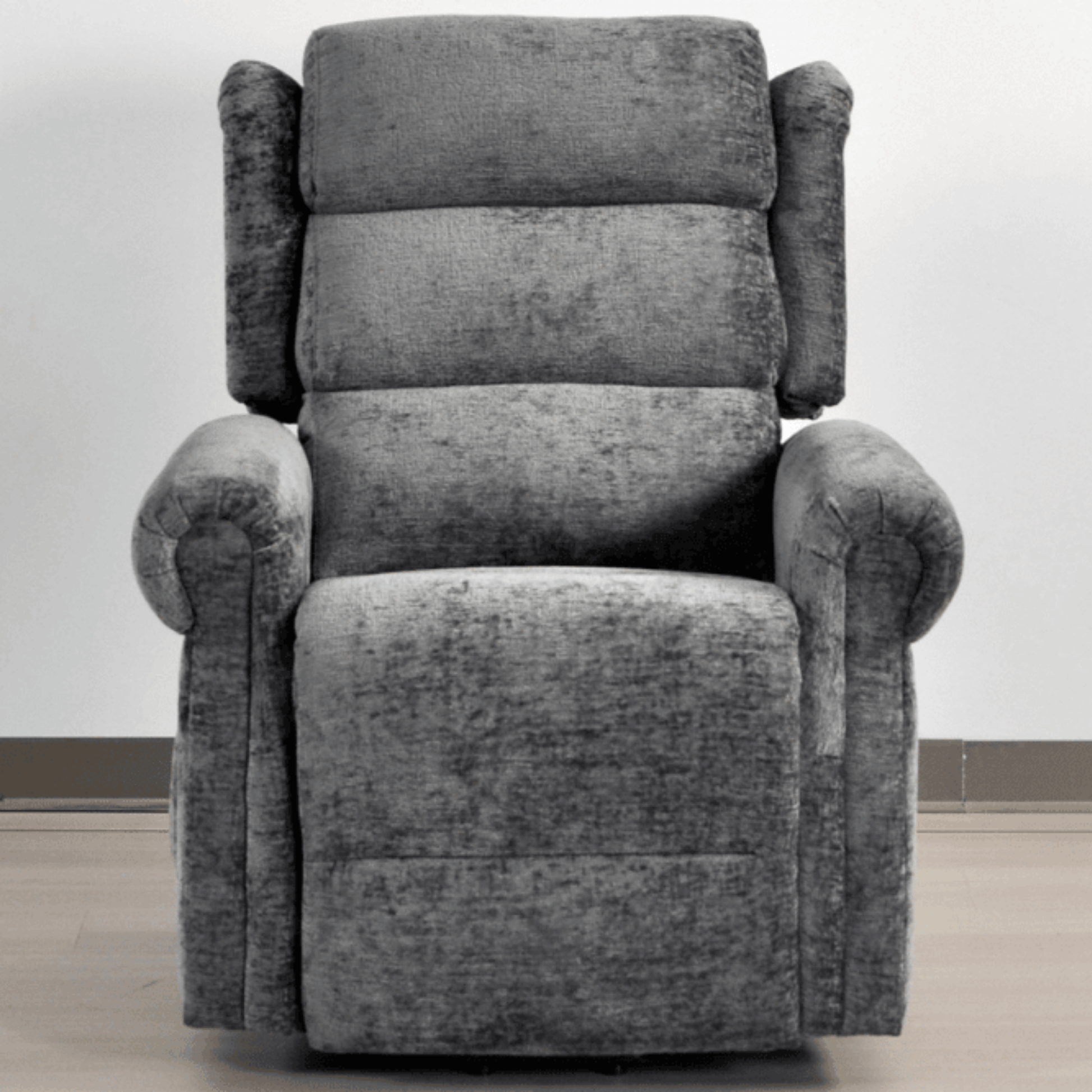 Gray recliner chair on a light wooden floor with a white wall background
