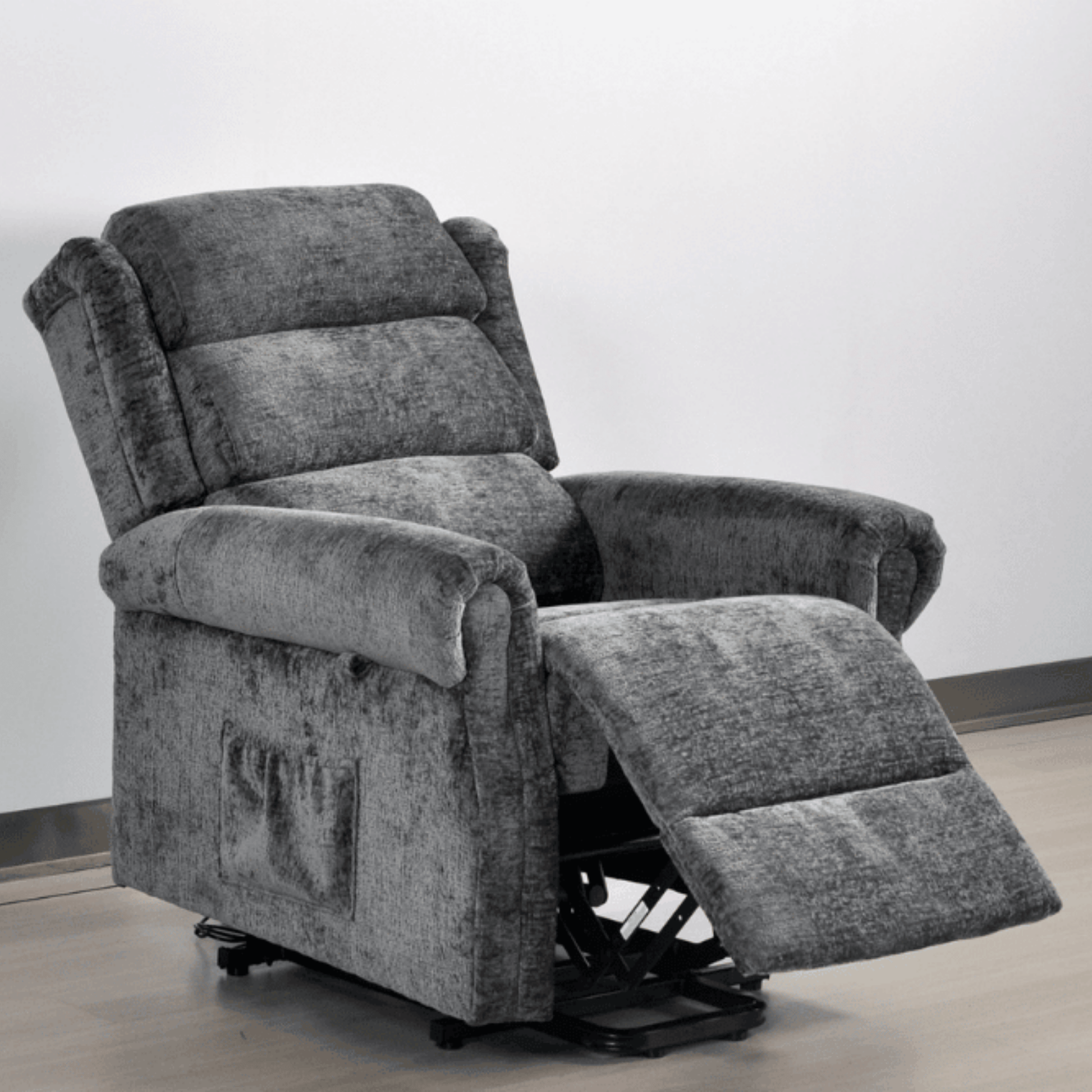 Gray recliner chair with armrests and footrest on a plain background