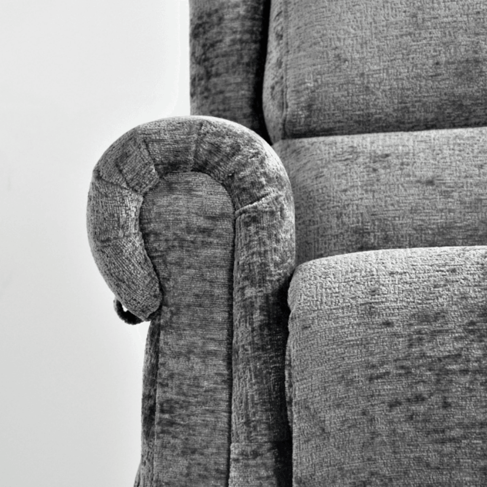 Gray upholstered chair with a textured fabric finish on a white background