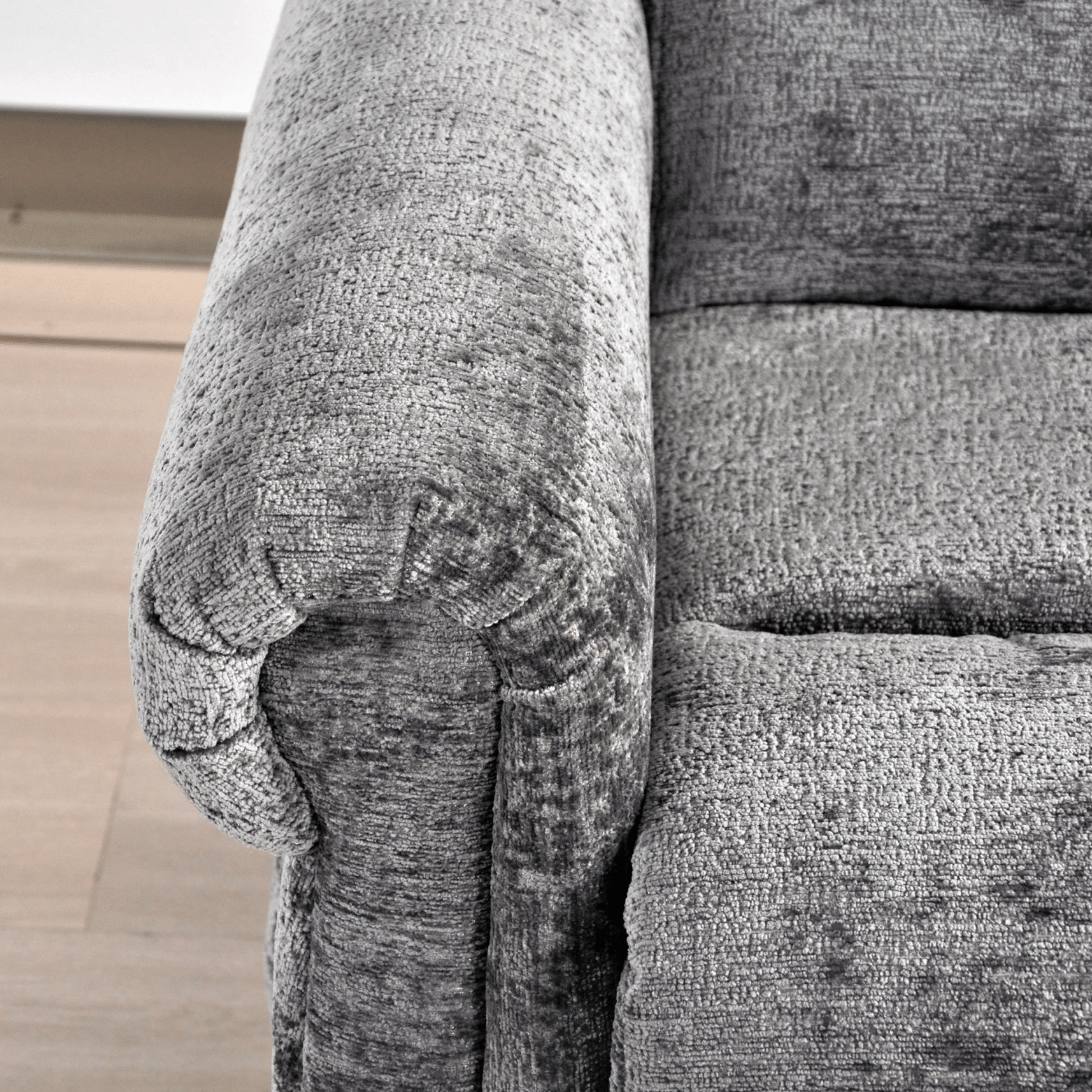 Gray textured fabric on a piece of furniture with a visible brand logo.