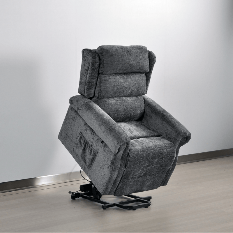 Gray recliner chair on a wooden floor with a white wall background