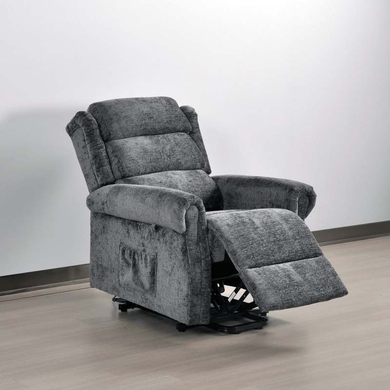Gray recliner chair on a wooden floor with a white wall background