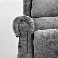 Gray upholstered chair with a curved armrest on a white background