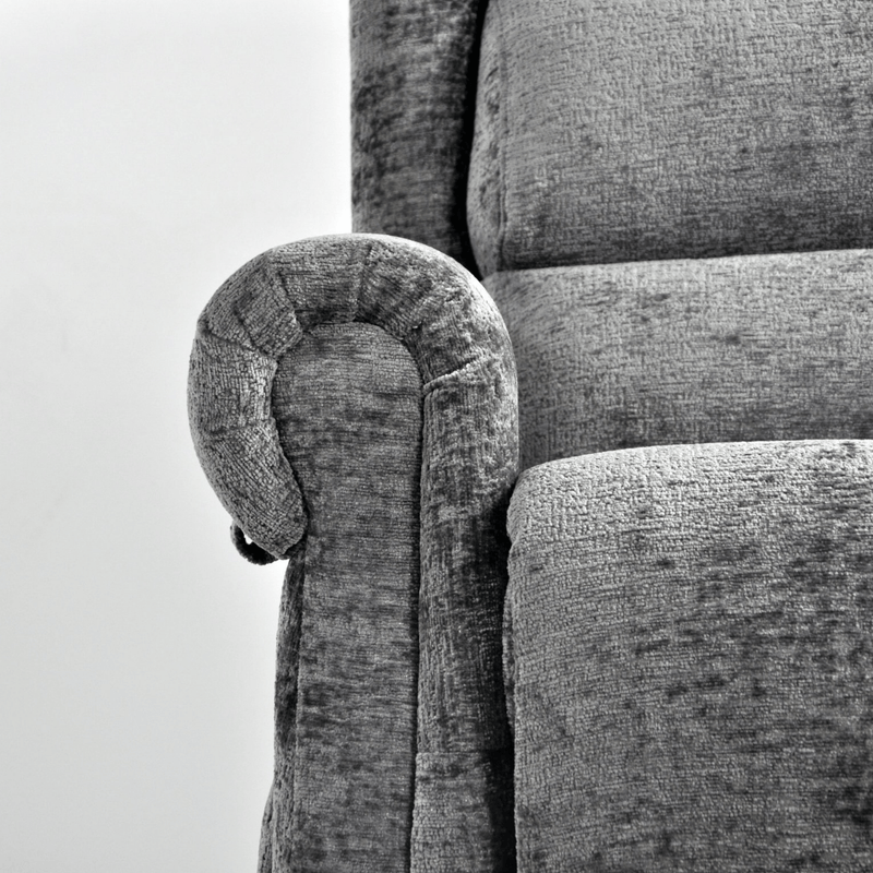 Gray upholstered chair with a curved armrest on a white background