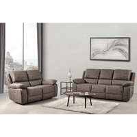 Brown sofa set in a living room with a coffee table and decorative items.