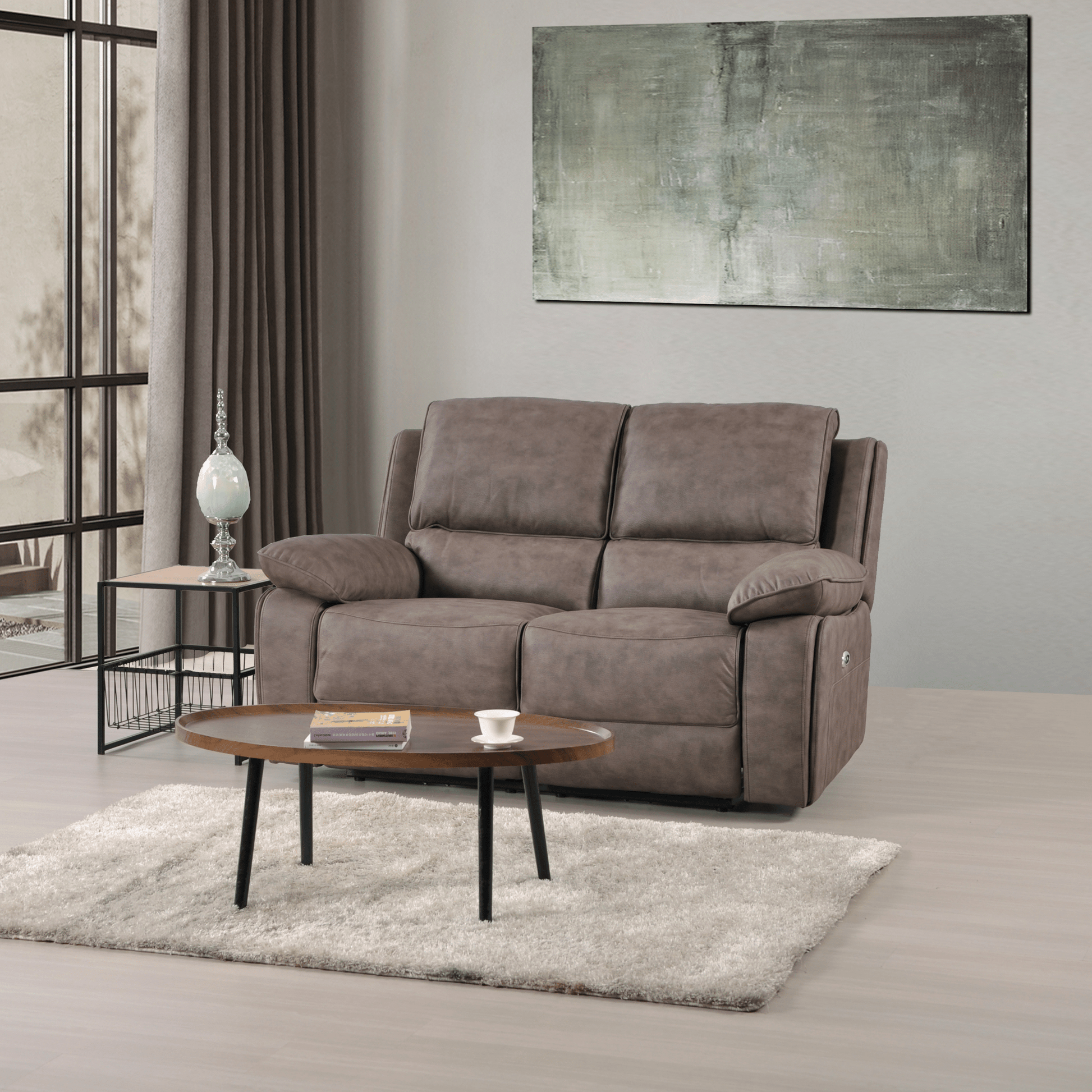 Gray sofa in a living room with a coffee table and abstract painting on the wall.