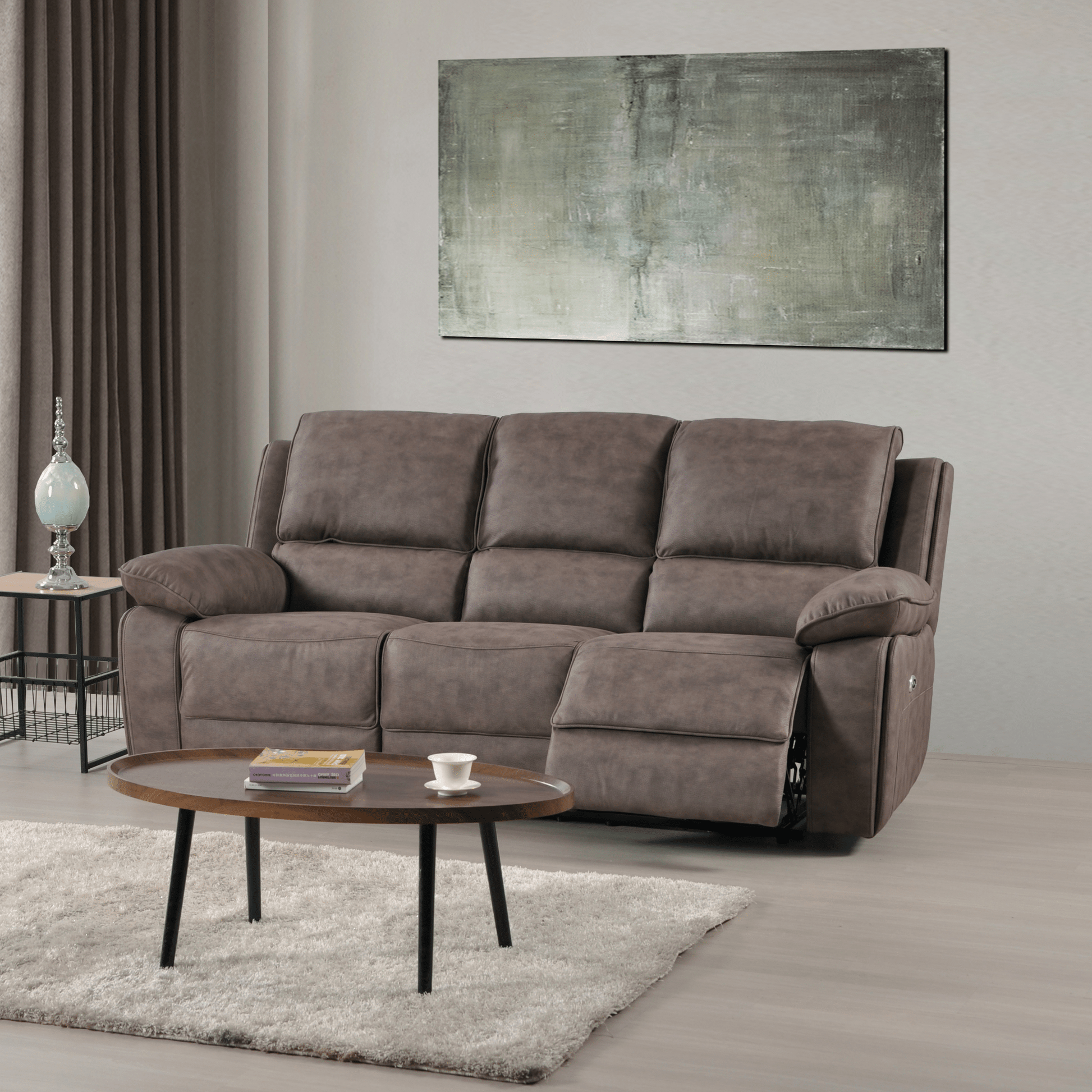 Brown sofa in a living room with a coffee table and abstract painting on the wall.