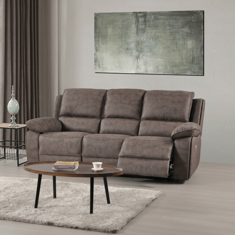 Brown sofa in a living room with a coffee table and abstract painting on the wall.