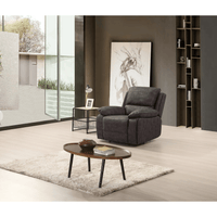 Gray recliner chair in a modern living room with a coffee table and bookshelf.