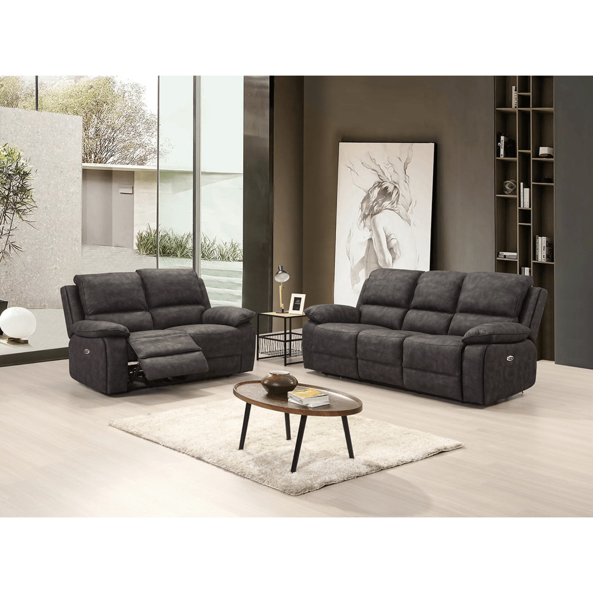 Gray reclining sofa set in a modern living room with a coffee table and decor.