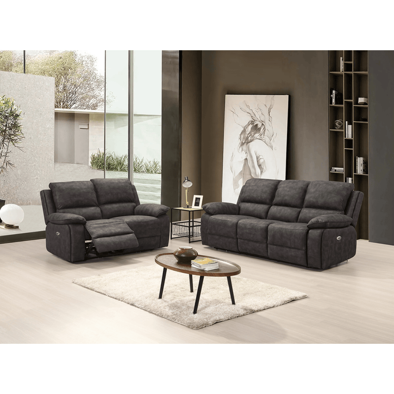 Gray reclining sofa set in a modern living room with a coffee table and decor.