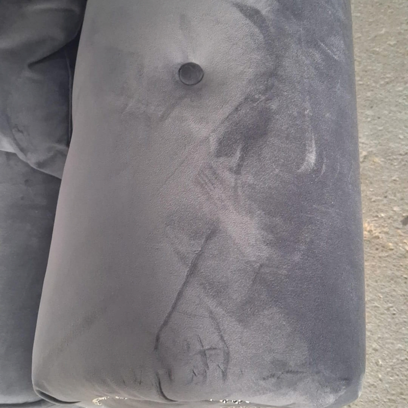 close up of grey velvet 2 seater sofa