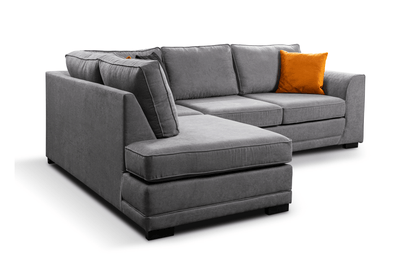 Okra Gray sectional sofa with an orange pillow on a white background