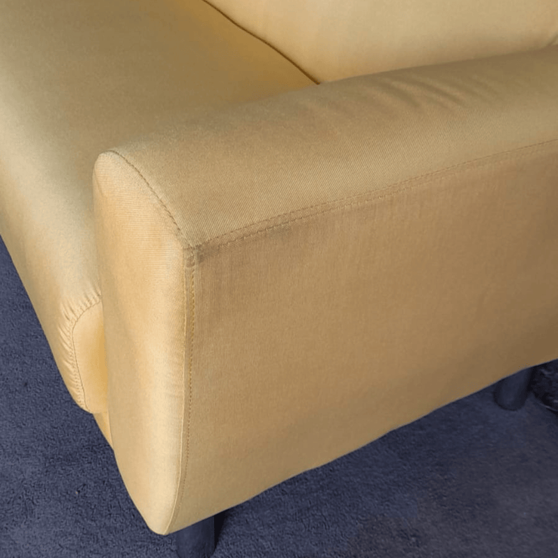Yellow sofa armrest on a blue carpet