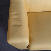 Yellow sofa armrest on a dark blue carpet