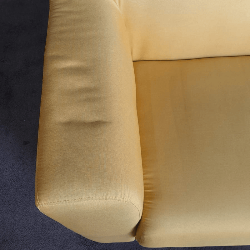 Yellow sofa armrest on a dark blue carpet