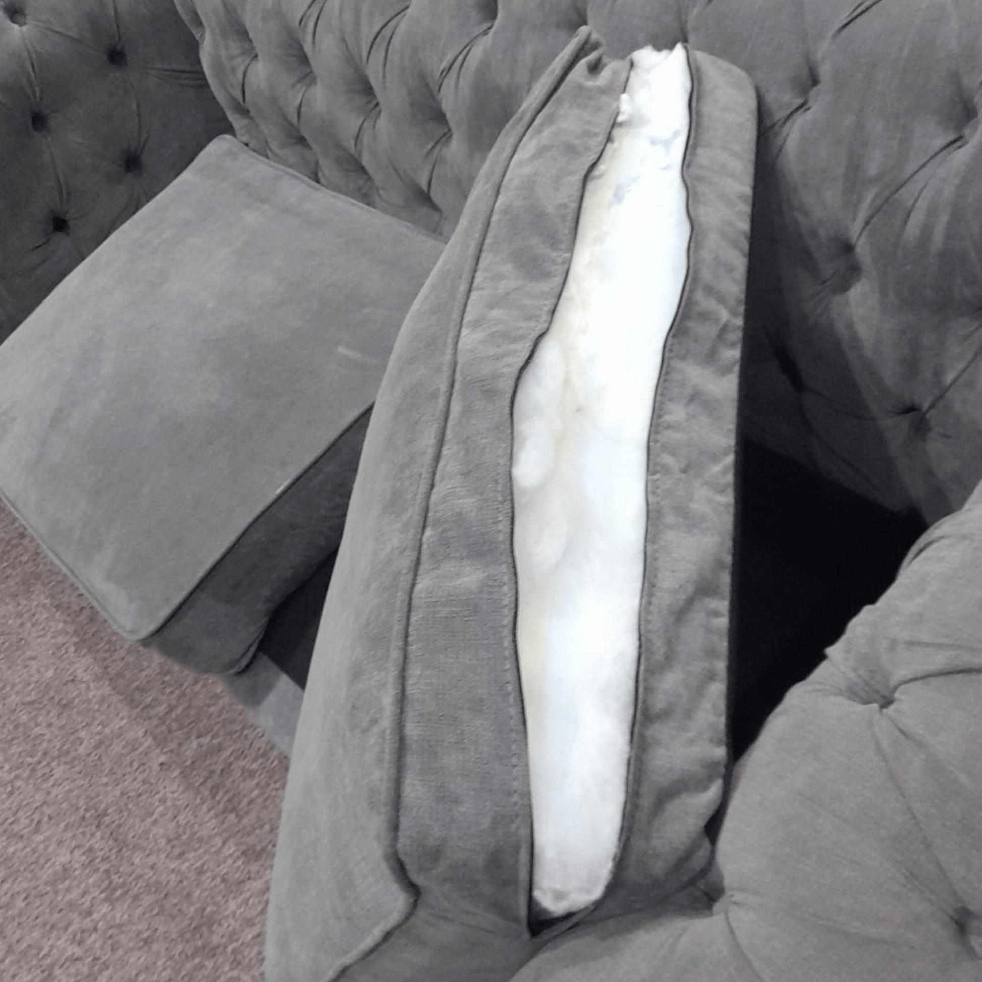 Gray sofa with a visible cushion and seat structure.