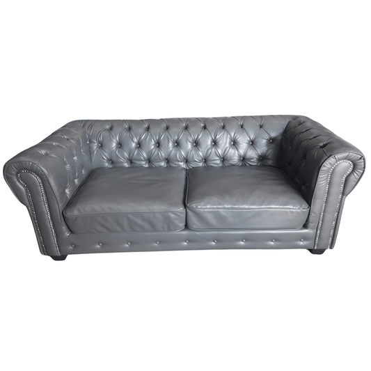 Gray tufted leather sofa on a white background