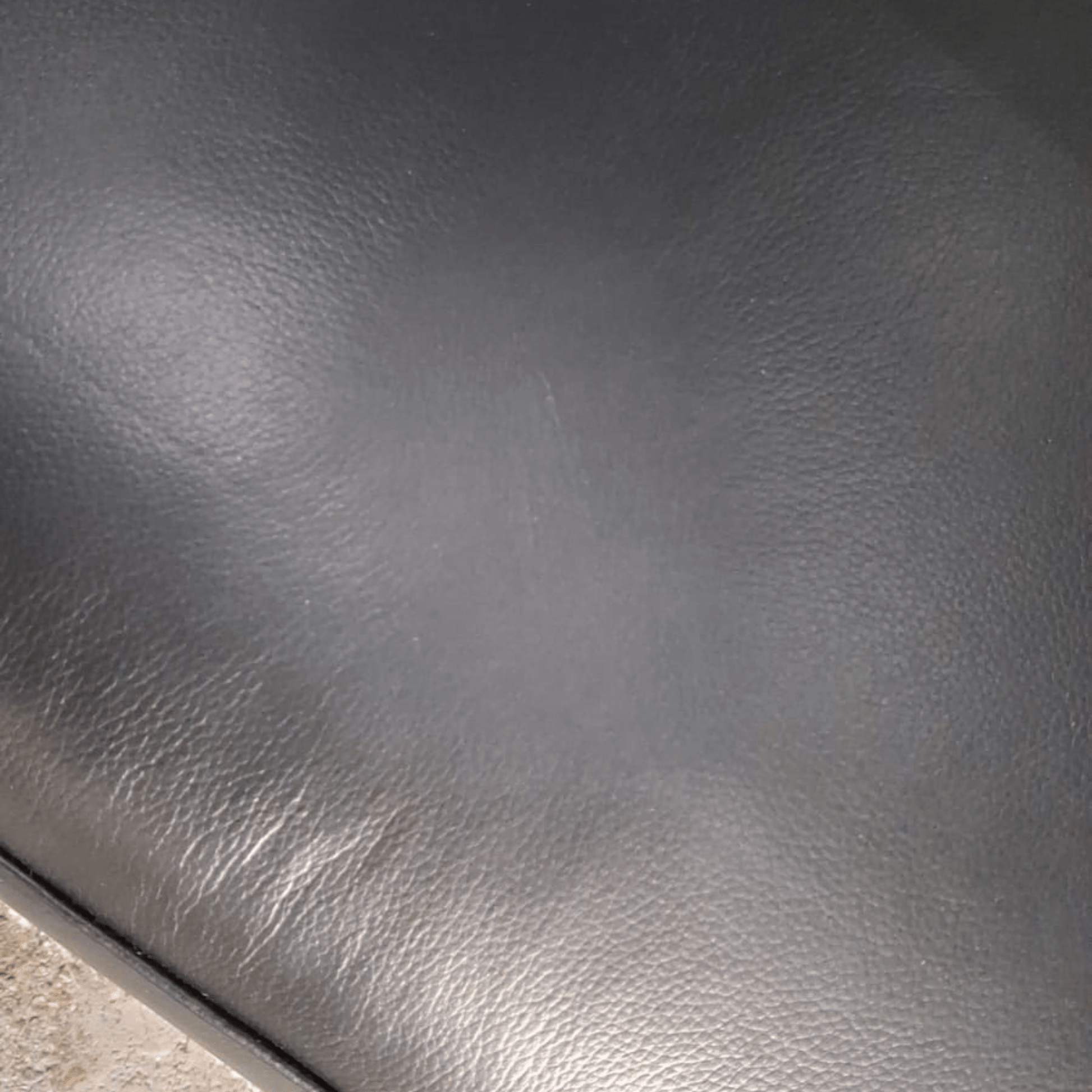 Close-up of dark gray leather surface