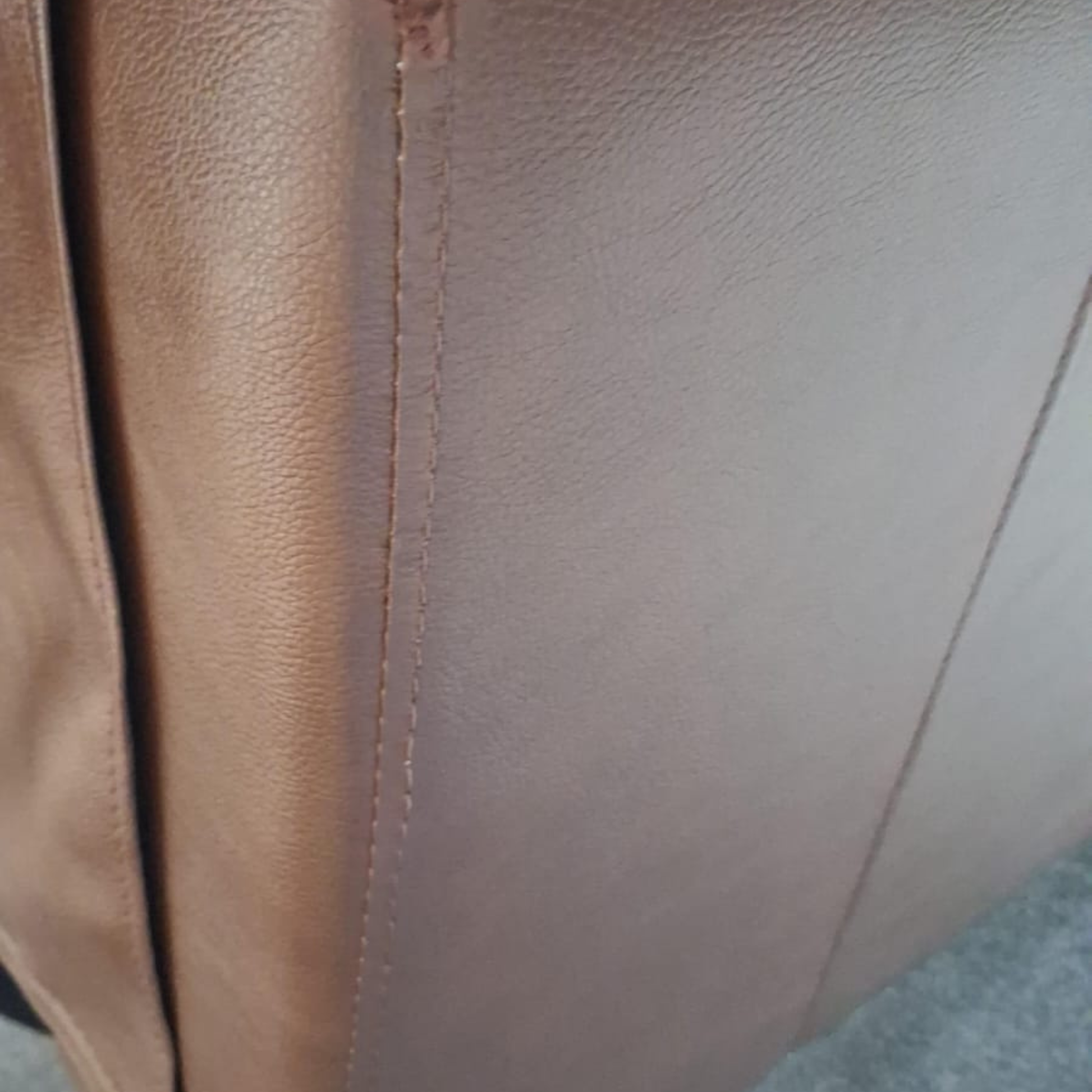 Close-up of brown leather texture with visible stitching