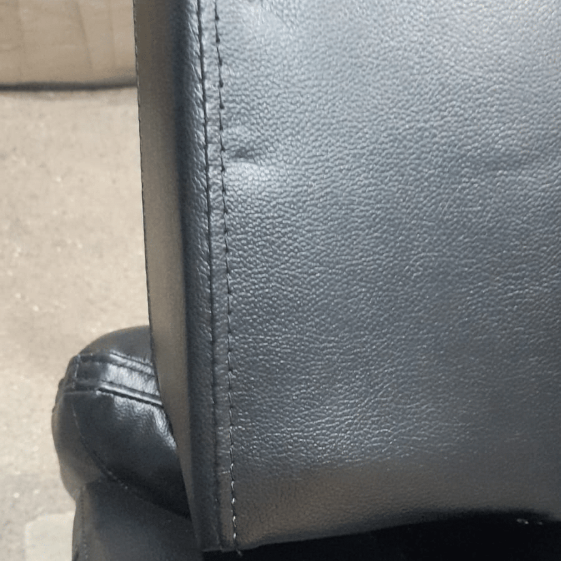 leather black sofa showing dents