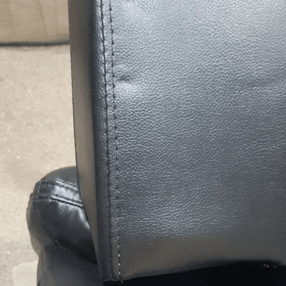 leather black sofa showing dents