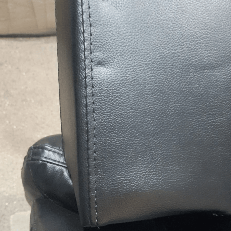 leather black sofa showing dents