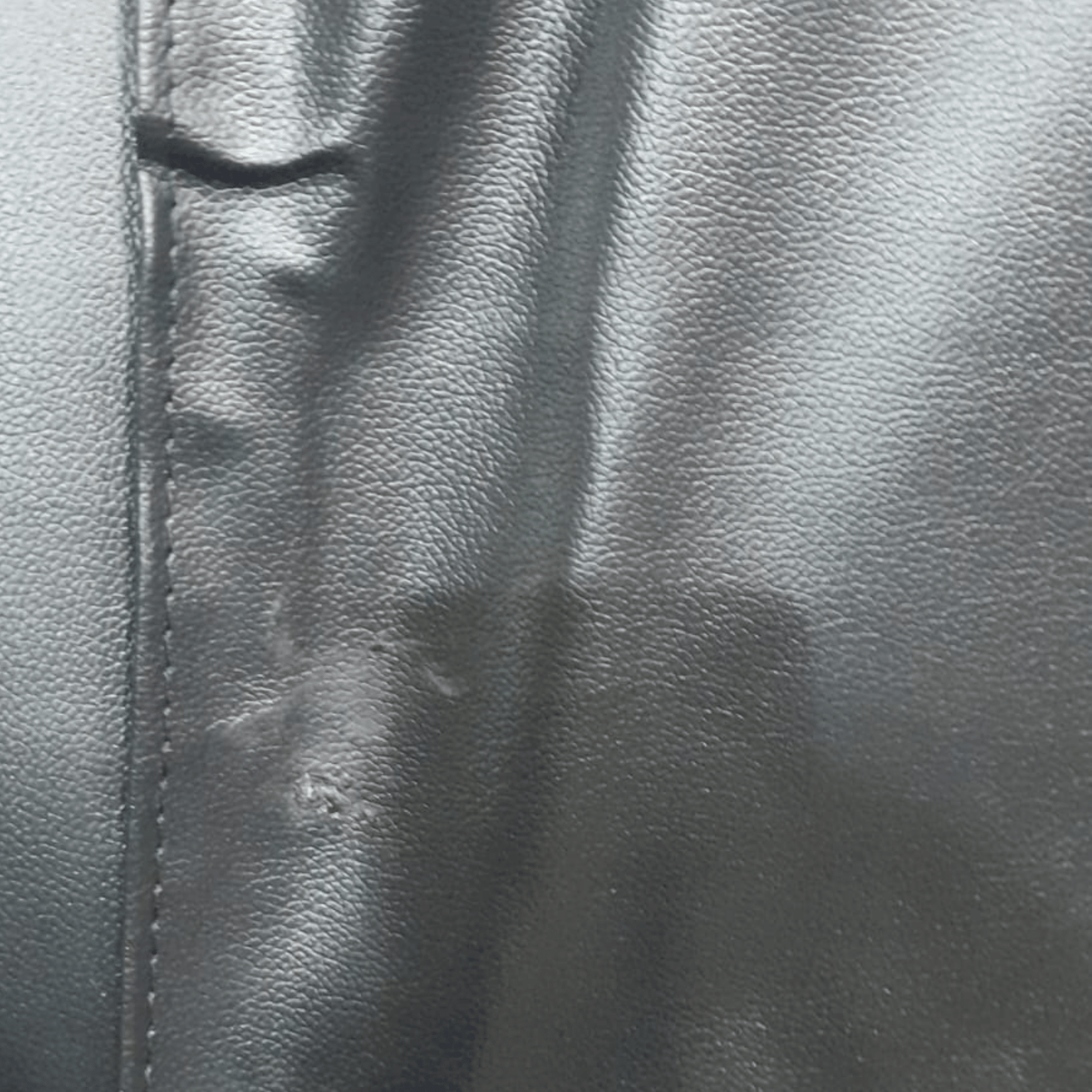 black leather sofa showing scuff marks.