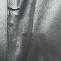 black leather sofa showing scuff marks.