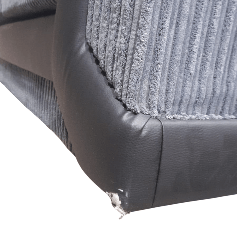 Close-up of a textured gray and black car seat cover corner.