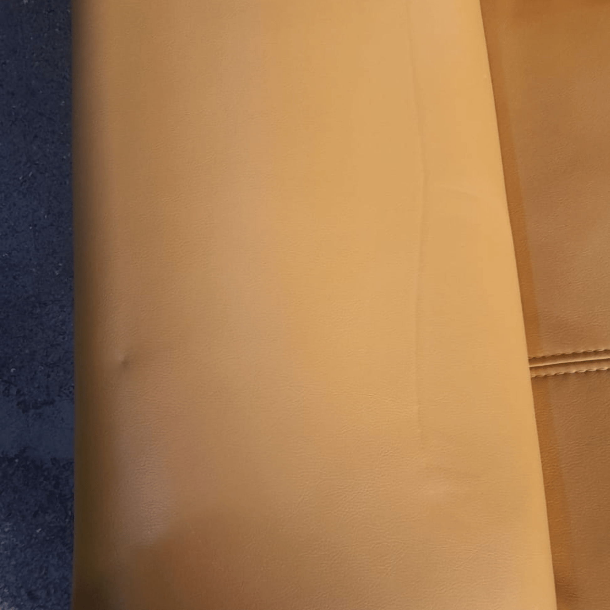 Close-up of a brown leather surface with a textured pattern.