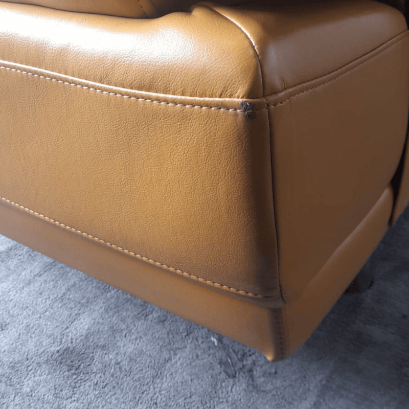 yellow leather armchair corner on a gray carpet