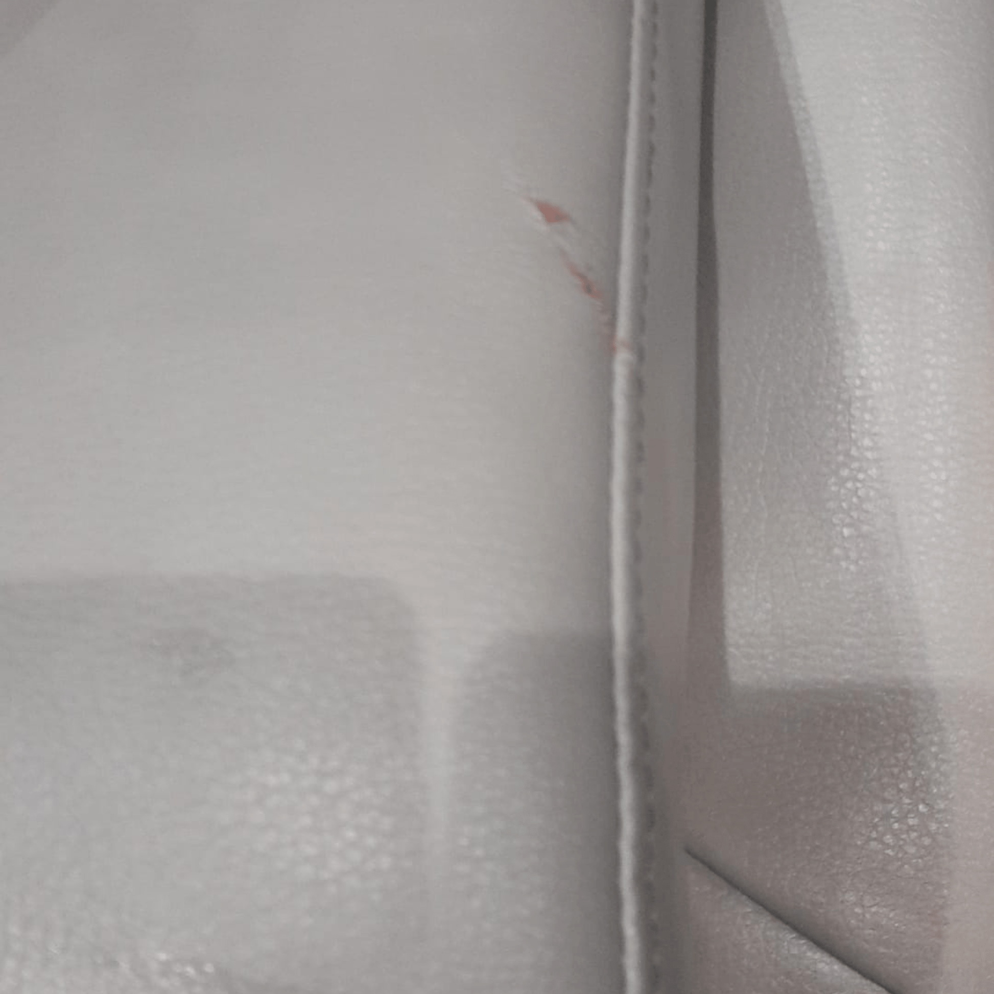 Close-up of a textured gray surface with a zipper