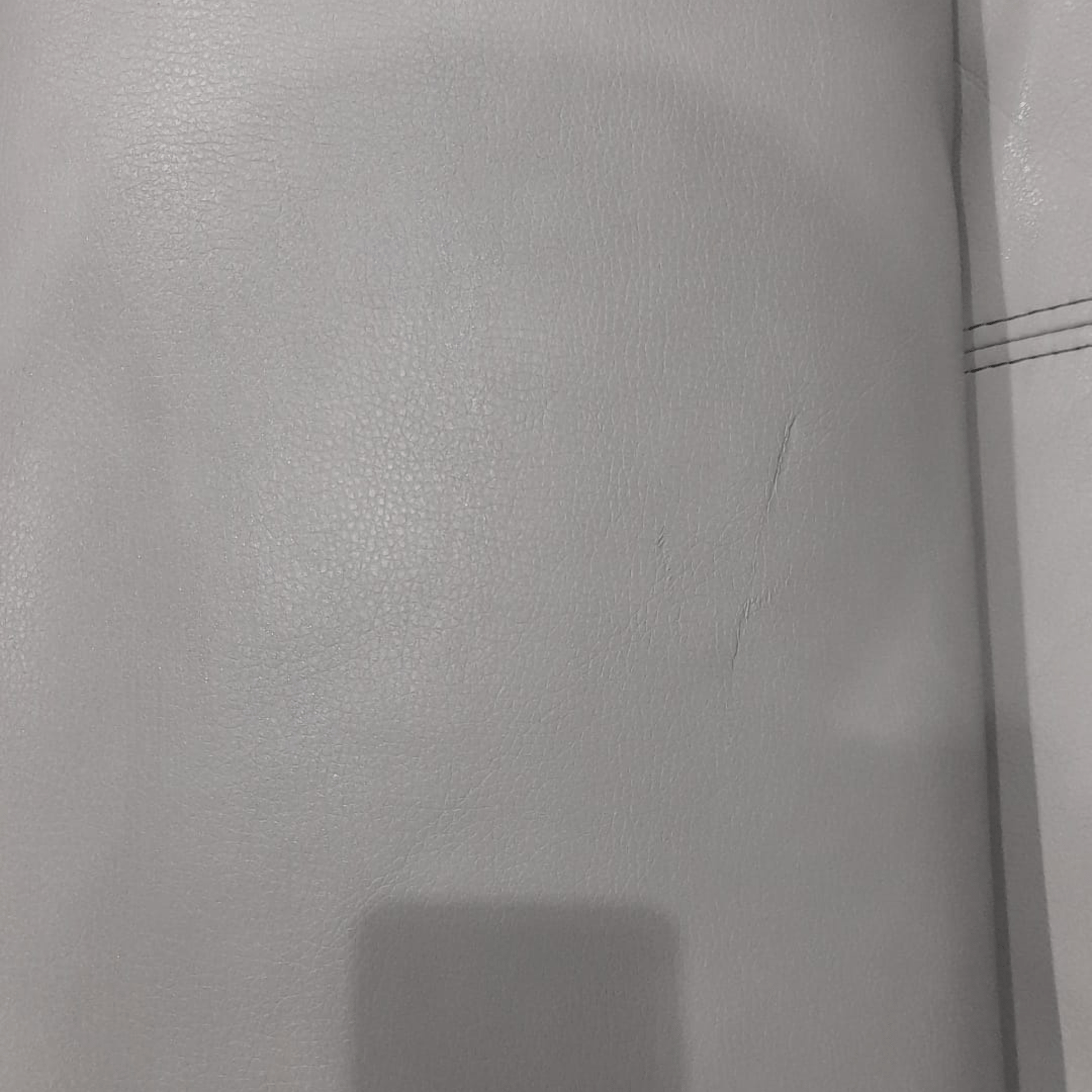 Close-up of a textured gray surface with a visible seam.