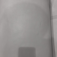 Close-up of a textured gray surface with a visible seam.