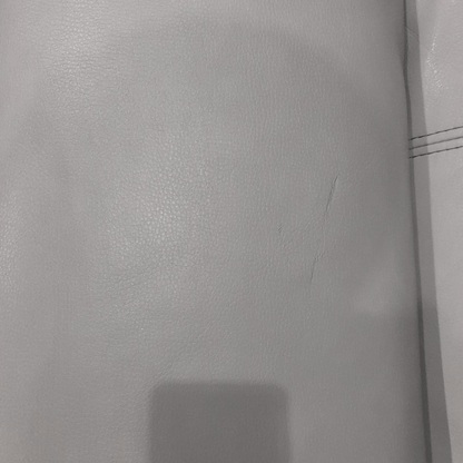 Close-up of a textured gray surface with a visible seam.