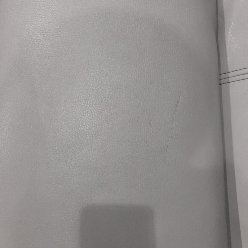 Close-up of a textured gray surface with a visible seam.