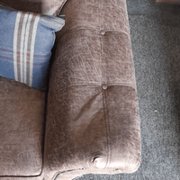 Brown textured fabric surface with buttons on a sofa