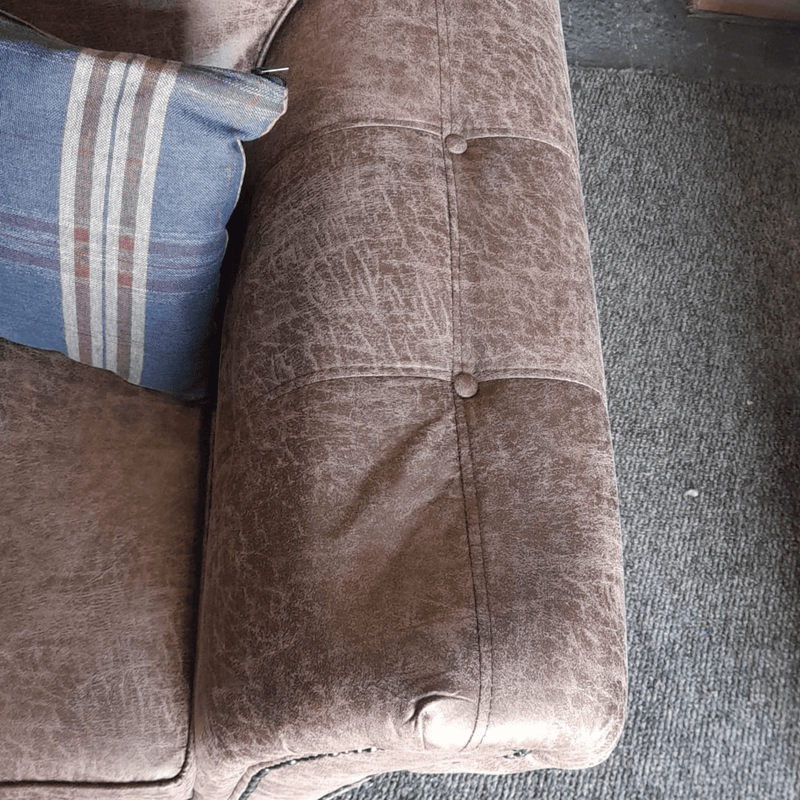 Brown textured fabric surface with buttons on a sofa