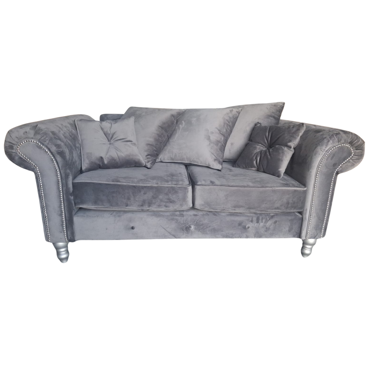 A gray velvet loveseat sofa with rolled arms, silver nailhead trim, and silver-toned legs, accompanied by four matching gray throw pillows, shown against a plain white background.
