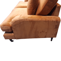 Brown sofa with a worn-out appearance on a white background