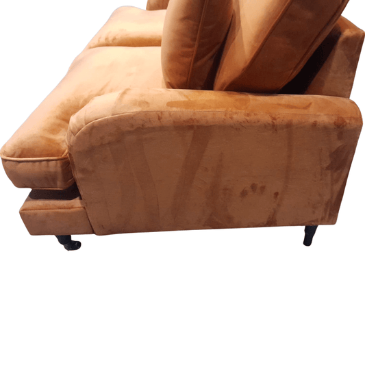 Brown sofa with a worn-out appearance on a white background