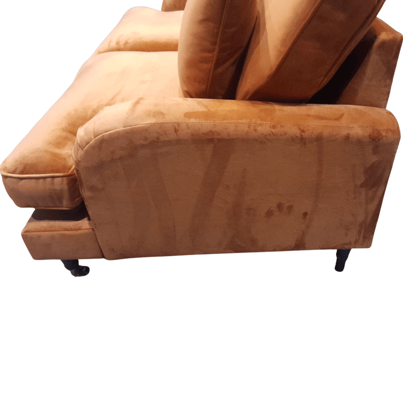 Brown sofa with a worn-out appearance on a white background