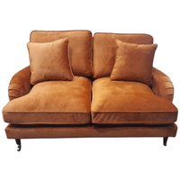 Brown sofa with two cushions on a white background