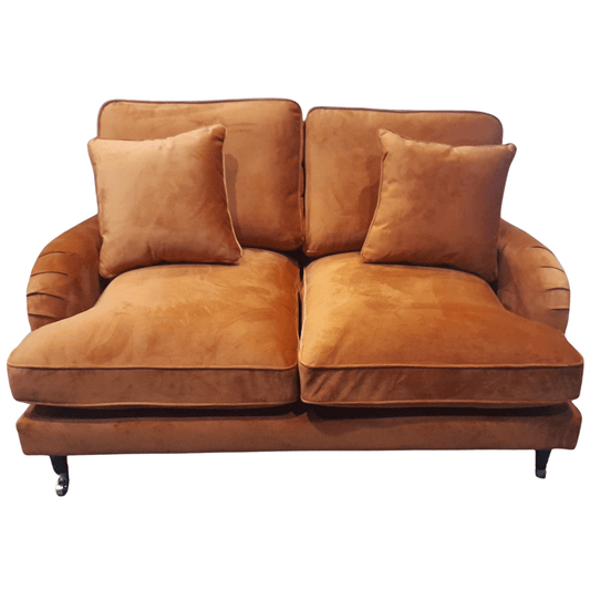Brown sofa with two cushions on a white background