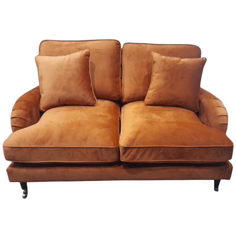 Brown sofa with two cushions on a white background
