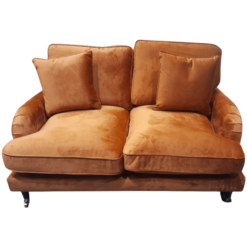 Brown velvet sofa with cushions on a white background