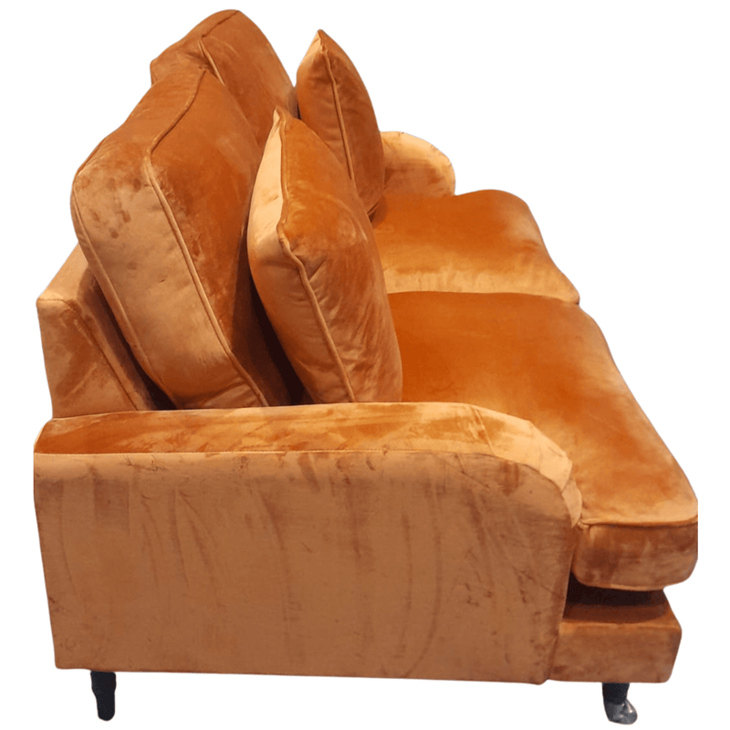 Brown velvet sofa with cushions on a white background