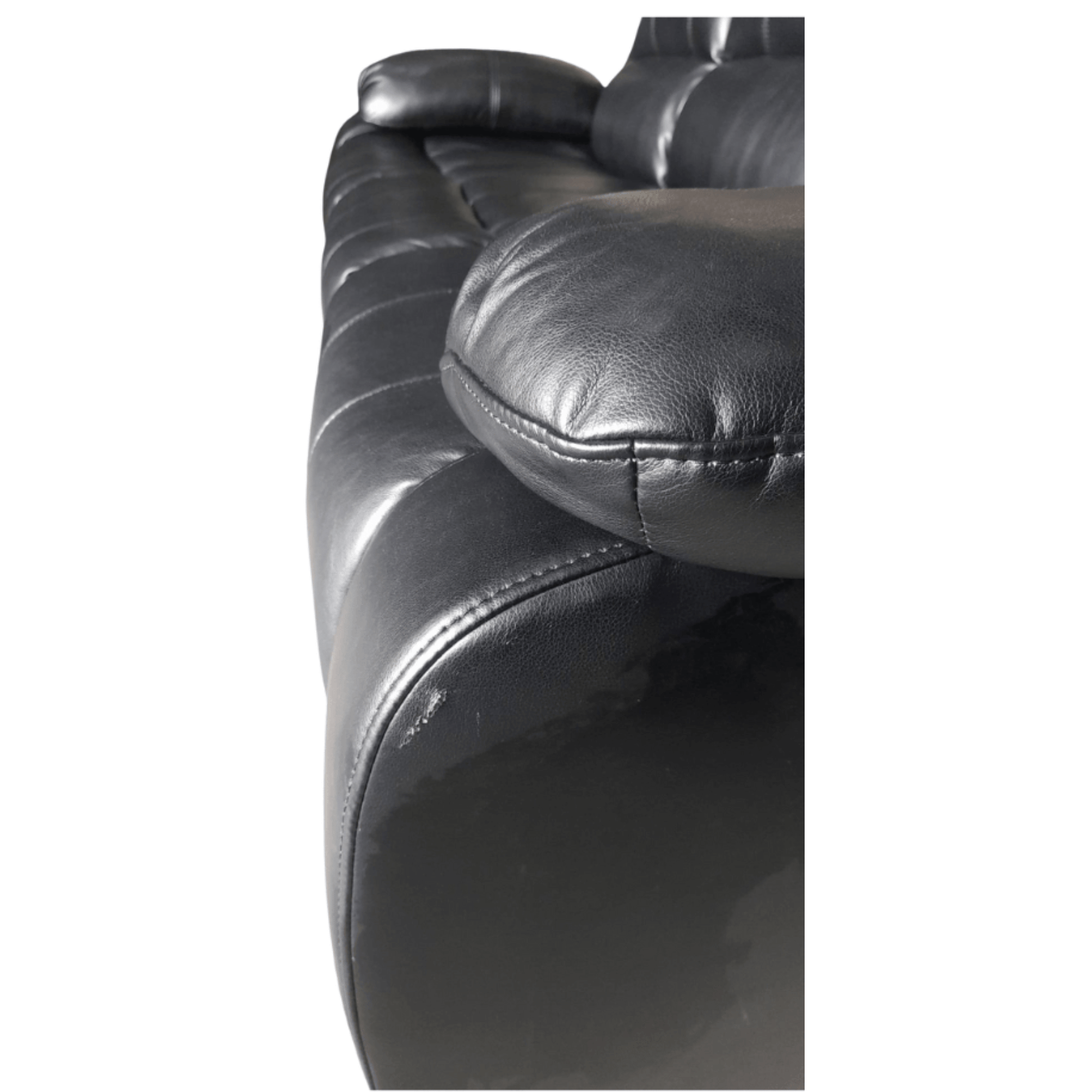 Close-up of a black leather sofa with visible stitching on a white background